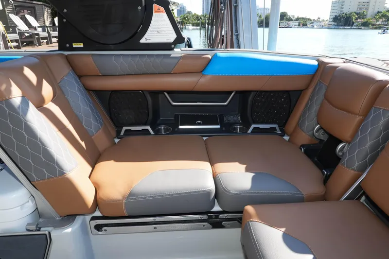  Yacht Photos Pics 2020 Malibu M240 boat interior with brown and gray cushioned seating, waterfront view.