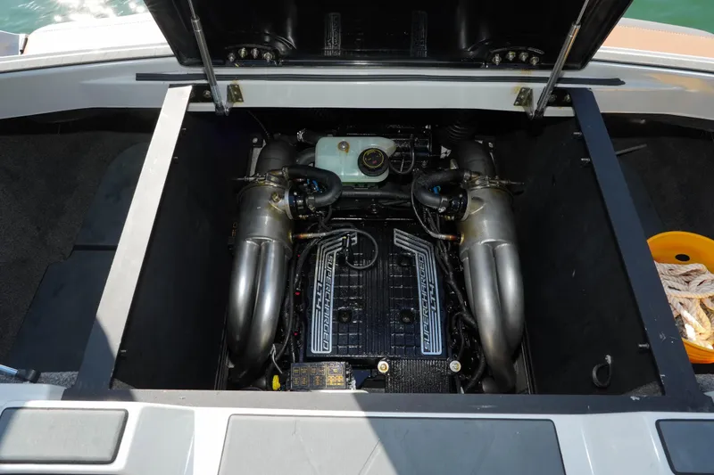  Yacht Photos Pics 2020 Malibu M240 boat engine compartment with supercharged engine components visible.
