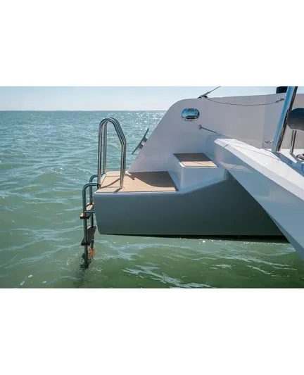 Kaya Yacht Photos Pics Neel 43 trimaran, 2021 model, rear view with swim ladder and steps in ocean.