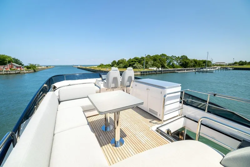 Second Chances Yacht Photos Pics Luxurious 2024 Azimut S7 yacht deck with seating, table, and scenic waterway view.