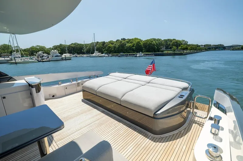 Second Chances Yacht Photos Pics Luxurious 2024 Azimut S7 yacht deck with sunbed, overlooking serene marina waters.