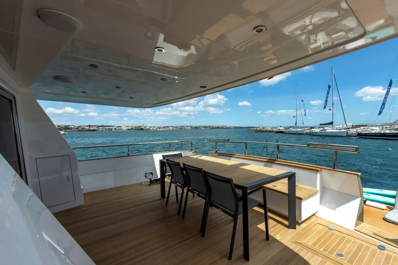  Yacht Photos Pics Versilcraft FALCON 82 yacht deck with dining area, overlooking marina, 1987 model.