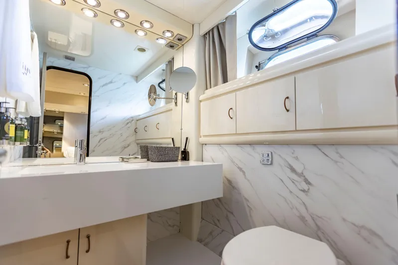  Yacht Photos Pics Luxurious bathroom in 1987 Versilcraft FALCON 82 yacht with marble accents and modern fixtures.