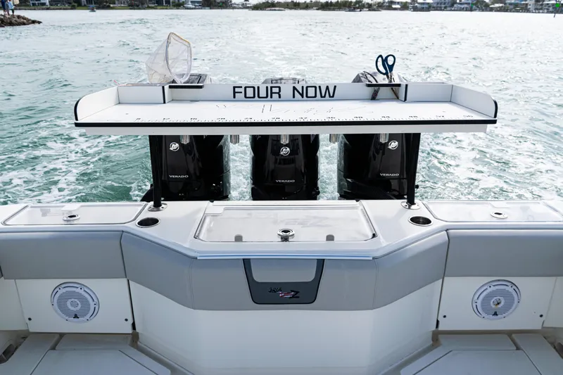 Yacht Photos Pics 2015 SeaVee 390Z boat with triple Mercury engines, fishing station, and ocean backdrop.