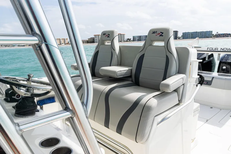  Yacht Photos Pics 2015 SeaVee 390Z boat interior with dual gray seats, ocean view, and city skyline.