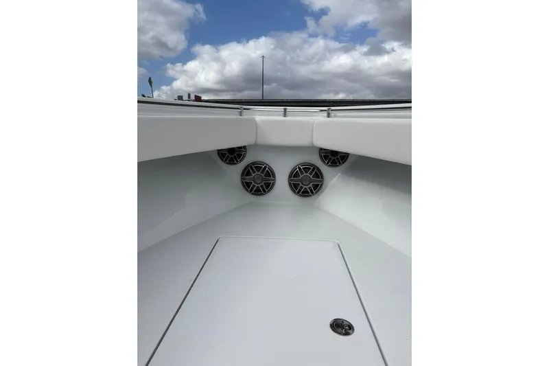  Yacht Photos Pics 2025 Contender 32 ST boat interior with speakers, under a cloudy sky.