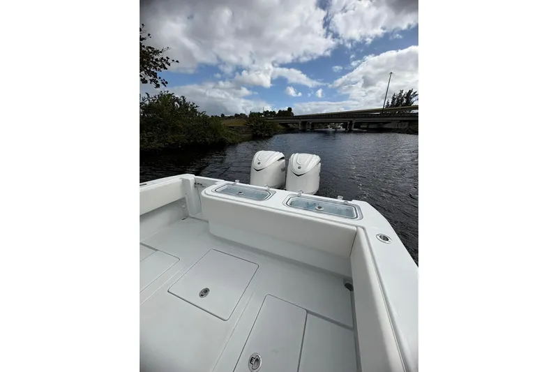  Yacht Photos Pics 2025 Contender 32 ST boat on water, featuring dual engines and spacious deck.