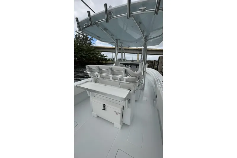  Yacht Photos Pics 2025 Contender 32 ST boat interior with seating and storage, under a sleek canopy.