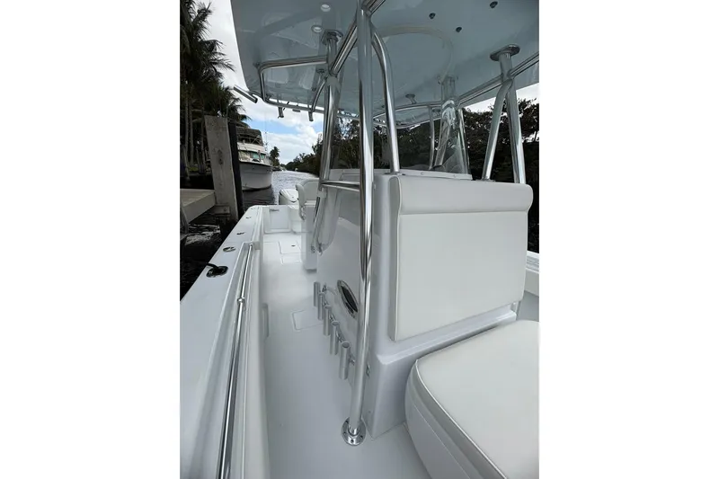  Yacht Photos Pics 2025 Contender 32 ST boat interior with sleek white seating and stainless steel fixtures.