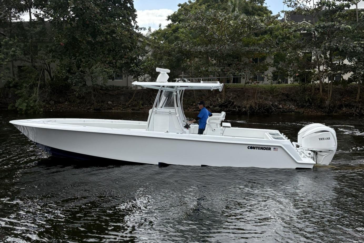 2025 Contender 32 ST boat on water, side view, with Yamaha engine.