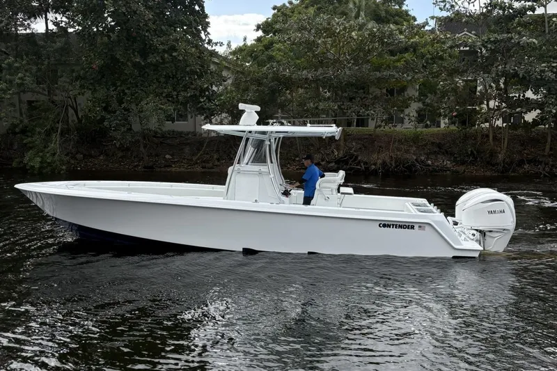  Yacht Photos Pics 2025 Contender 32 ST boat on water, side view, with Yamaha engine.