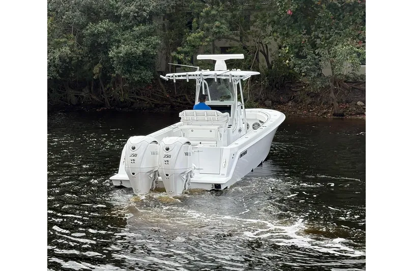  Yacht Photos Pics 2025 Contender 32 ST boat with dual engines on a calm river.