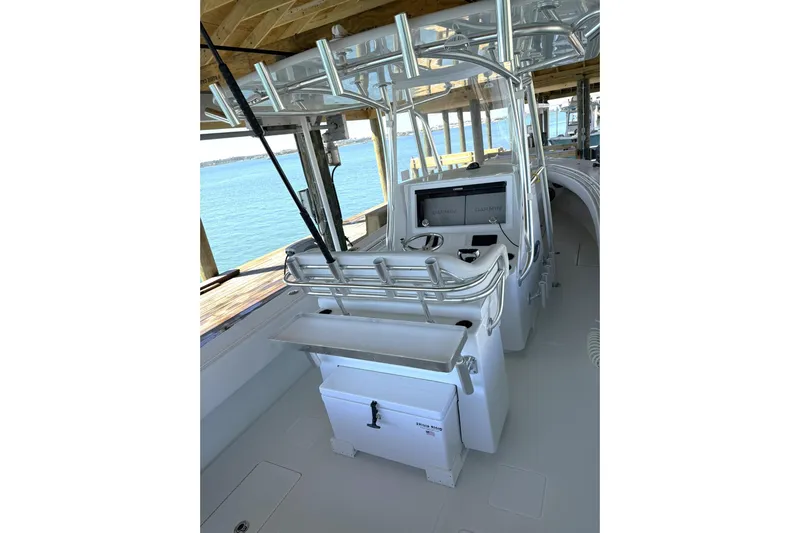  Yacht Photos Pics 2025 Contender 32 ST boat interior with helm station and fishing rod holders.