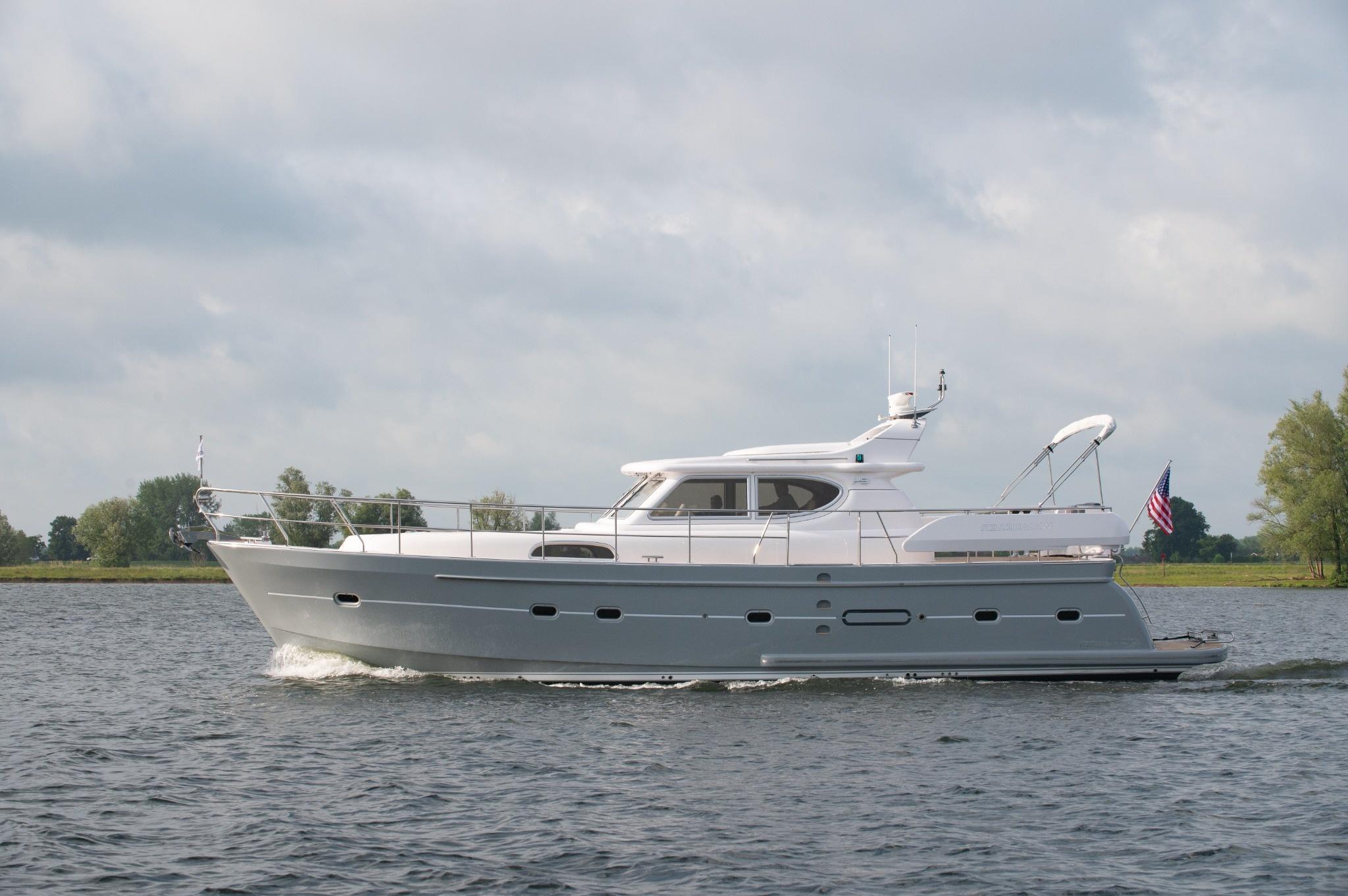 2026 Elling E4 yacht cruising on a calm river under a cloudy sky.