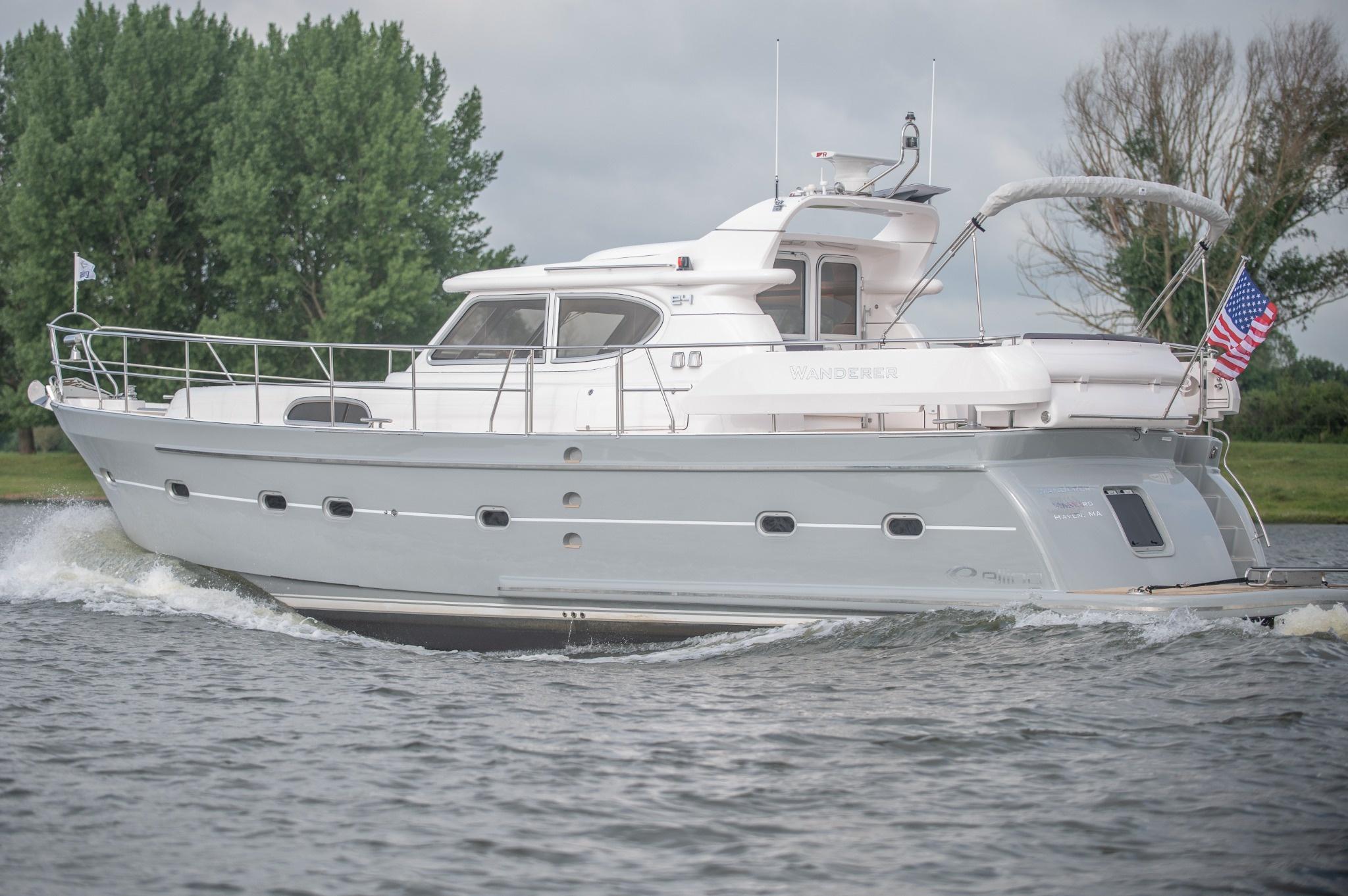 2026 Elling E4 yacht cruising on a river with trees in the background.