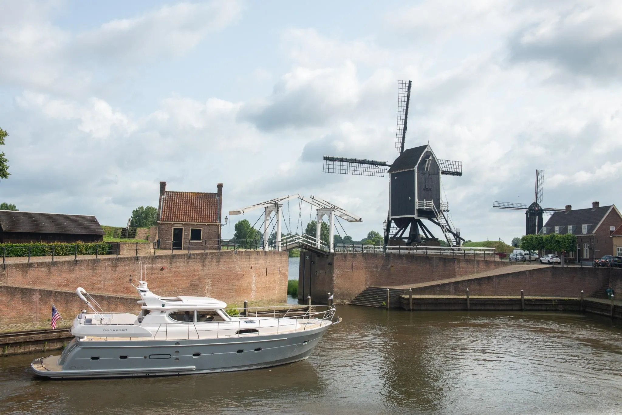 Elling E4 yacht cruising near historic windmills and a drawbridge, 2026.