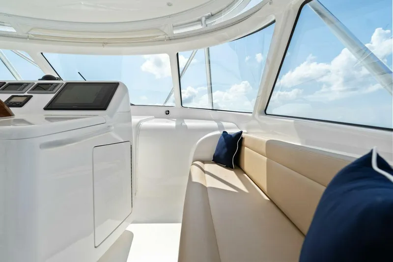 Mahirita Yacht Photos Pics Interior of 2014 Viking 42 Open yacht with beige seating and blue pillows.