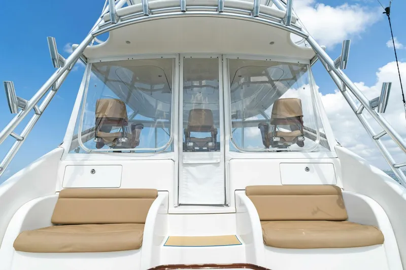 Mahirita Yacht Photos Pics 2014 Viking 42 Open boat with tan seating and clear enclosure.