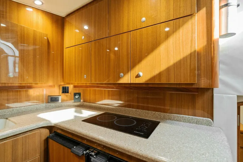 Mahirita Yacht Photos Pics Modern kitchen in 2014 Viking 42 Open yacht with wooden cabinets and electric cooktop.