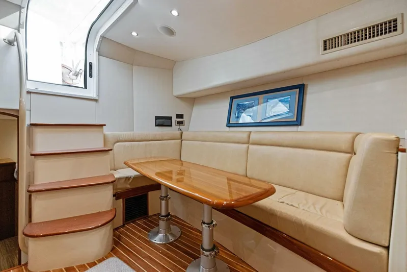 Mahirita Yacht Photos Pics 2014 Viking 42 Open yacht interior with beige seating and wooden table.