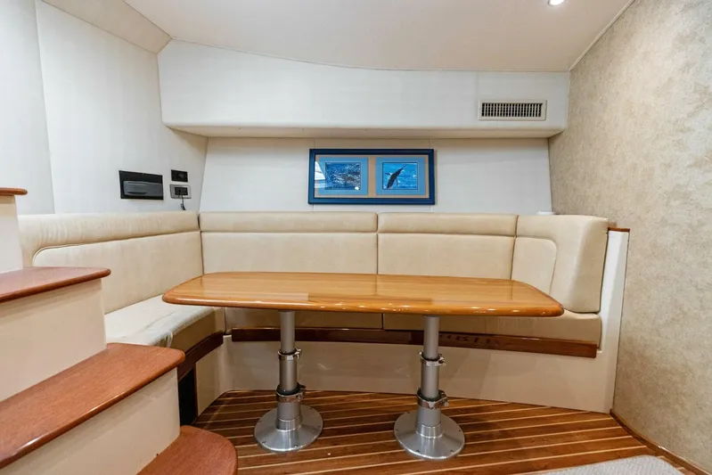 Mahirita Yacht Photos Pics 2014 Viking 42 Open yacht interior with dining area and wooden table.