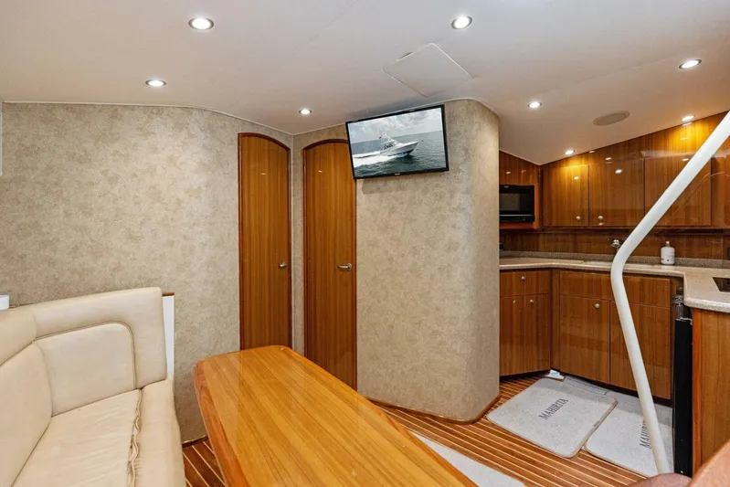 Mahirita Yacht Photos Pics Interior of 2014 Viking 42 Open yacht with modern kitchen and cozy seating area.