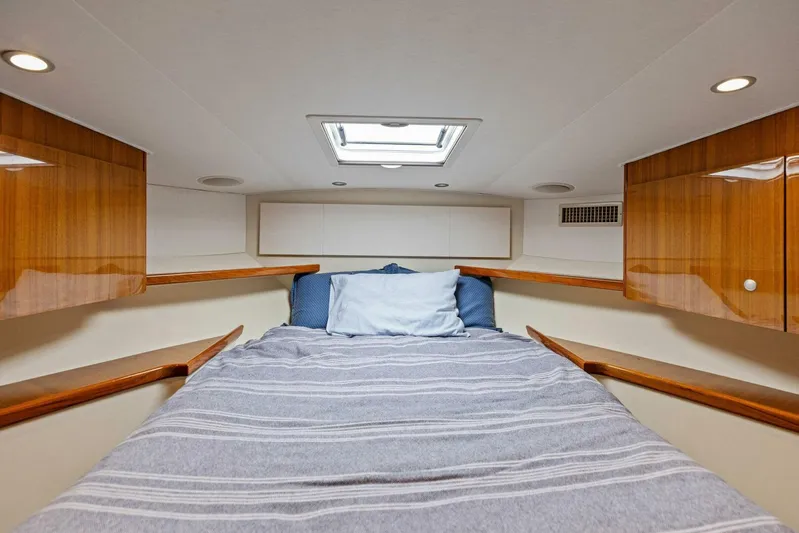 Mahirita Yacht Photos Pics 2014 Viking 42 Open cabin with bed, skylight, and wooden cabinets.