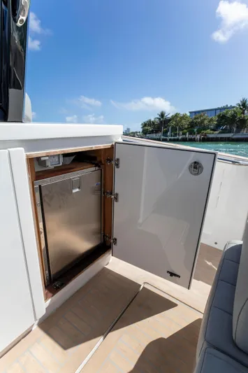 M/y Big Day Yacht Photos Pics 2022 Pardo Yachts 38, open cabinet with stainless steel interior, sunny day by the water.