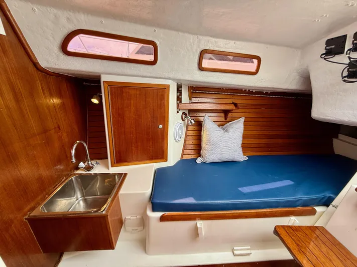 Easterly Yacht Photos Pics Cozy 2009 e Sailing Yachts e33 cabin interior with wooden finish and blue cushioned seating.