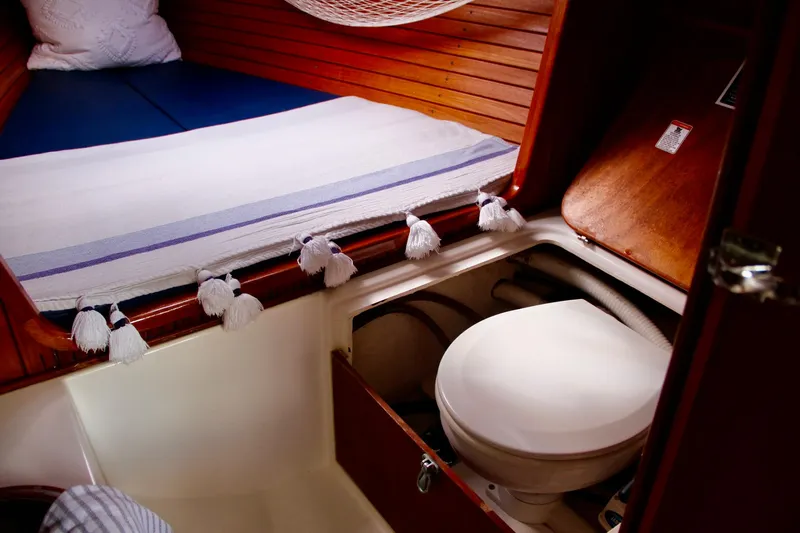 Easterly Yacht Photos Pics Interior of 2009 e Sailing Yachts e33, featuring a compact marine toilet and cozy sleeping area.