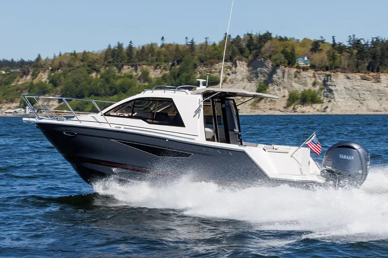  Yacht Photos Pics Manufacturer Provided Image: 2024 Solara S-250 Coupe boat cruising on a scenic lake.
