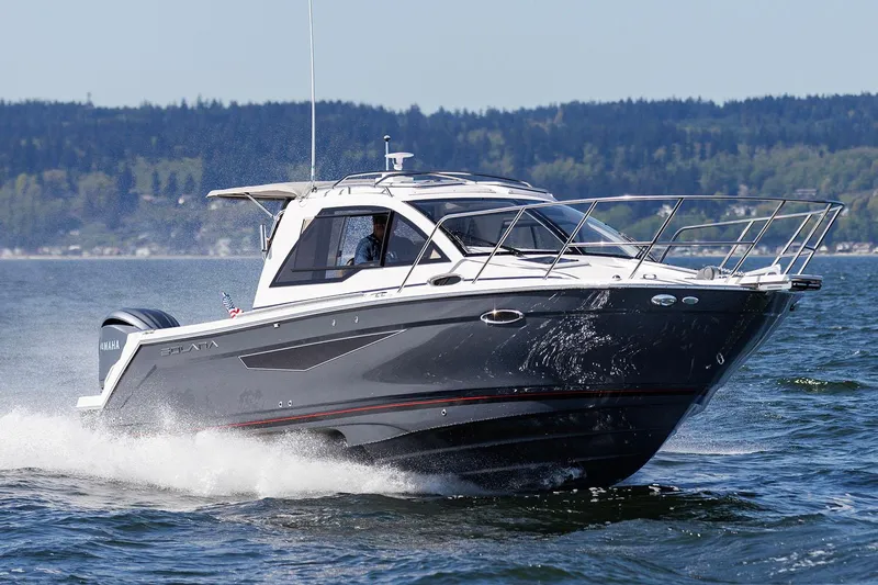  Yacht Photos Pics Manufacturer Provided Image: 2024 Solara S-250 Coupe cruising on a lake with forested hills in the background.