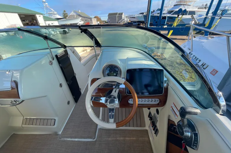  Yacht Photos Pics 2020 Chris-Craft Launch 28 GT cockpit with steering wheel and navigation display.