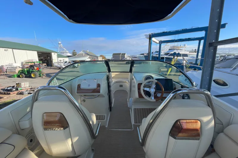  Yacht Photos Pics 2020 Chris-Craft Launch 28 GT boat interior with steering wheel and dashboard, docked at marina.