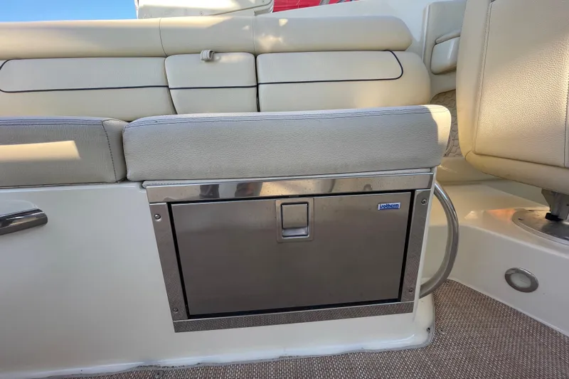  Yacht Photos Pics 2020 Chris-Craft Launch 28 GT interior with beige seating and built-in storage compartment.