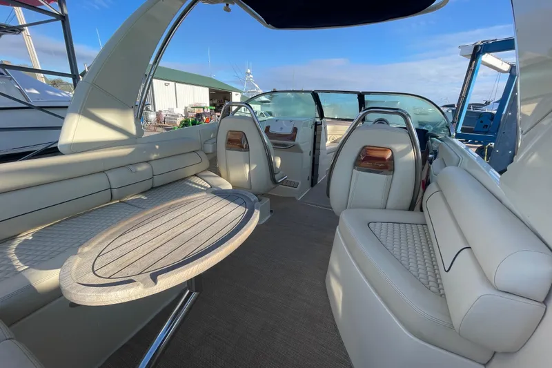  Yacht Photos Pics 2020 Chris-Craft Launch 28 GT interior with elegant seating and wooden table.