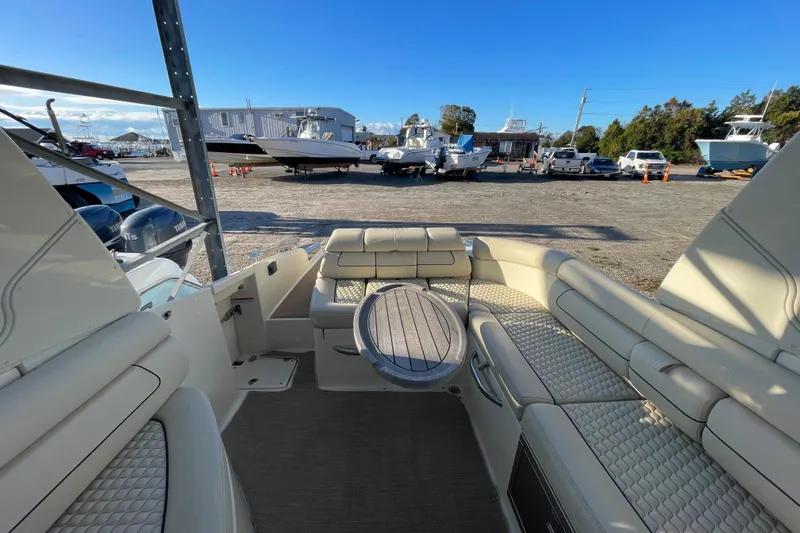  Yacht Photos Pics 2020 Chris-Craft Launch 28 GT interior with luxurious seating and table, docked outdoors.