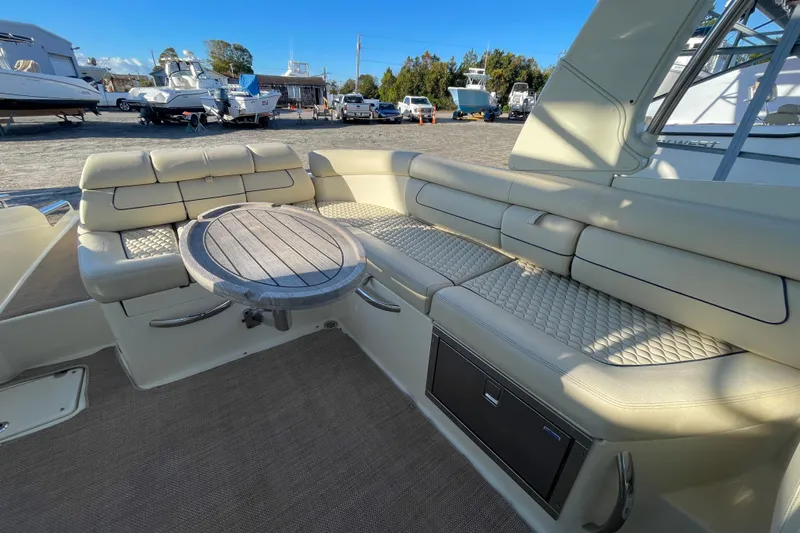  Yacht Photos Pics 2020 Chris-Craft Launch 28 GT interior with beige seating and wooden table.