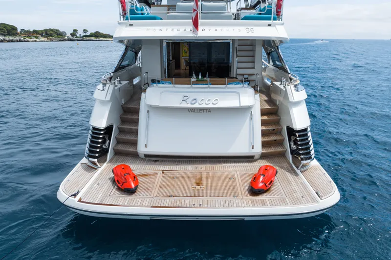 Rocco Yacht Photos Pics 2021 Monte Carlo Yachts MCY 96 rear view on water with swim platform.