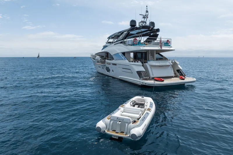 Rocco Yacht Photos Pics 2021 Monte Carlo Yachts MCY 96 luxury yacht with tender in open sea.