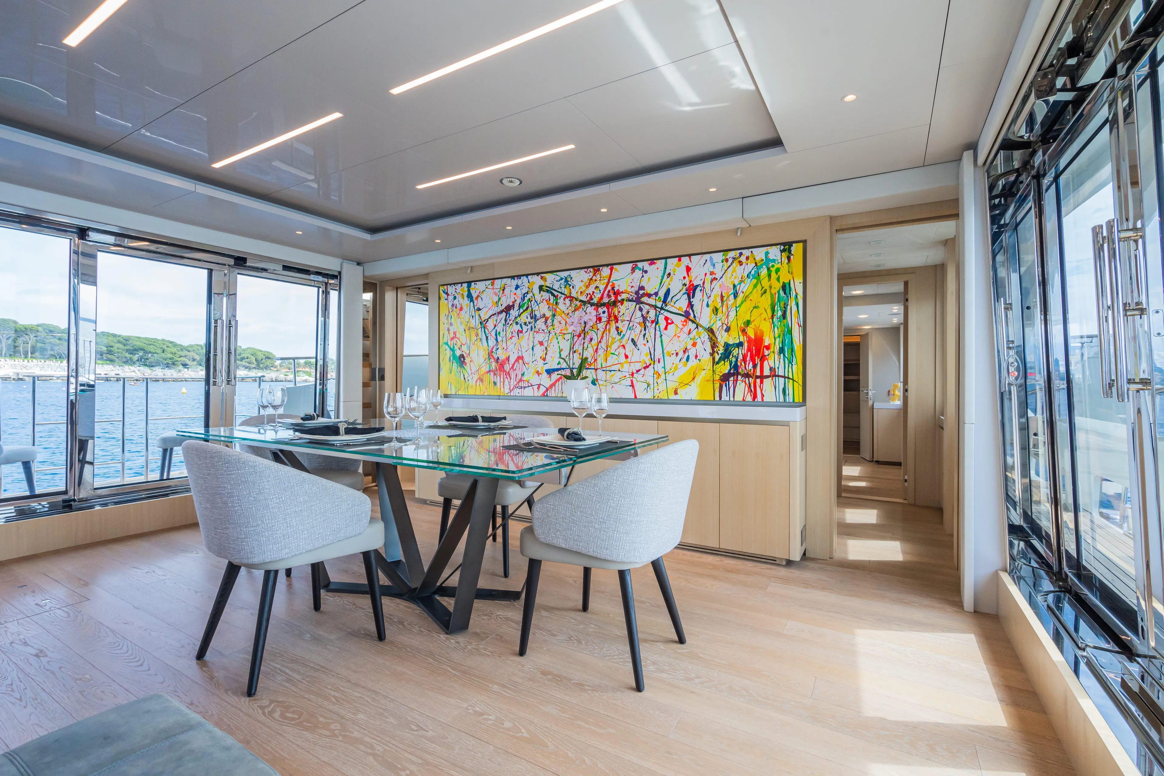 Rocco Yacht Photos Pics Modern dining area on 2021 Monte Carlo Yachts MCY 96 with abstract art and sea view.