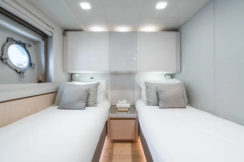 Rocco Yacht Photos Pics Modern twin bedroom on 2021 Monte Carlo Yachts MCY 96 with porthole window.
