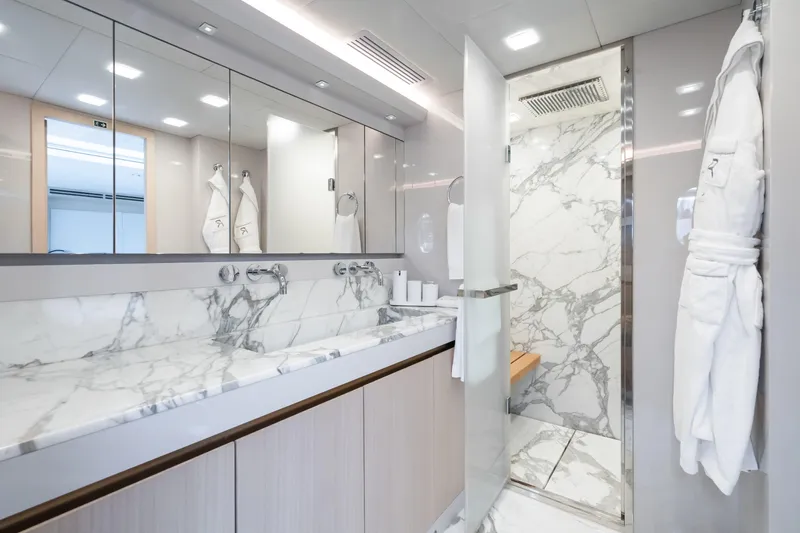 Rocco Yacht Photos Pics Luxurious bathroom in 2021 Monte Carlo Yachts MCY 96 with marble finishes and modern fixtures.