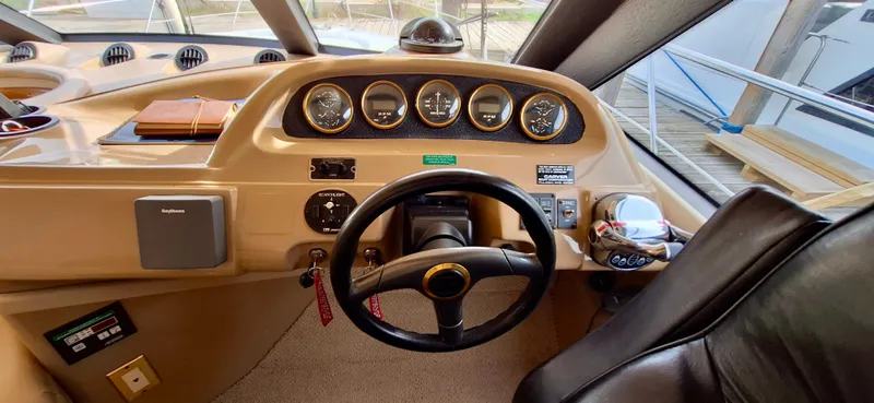 Regina Rae Yacht Photos Pics 1999 Carver 450 Voyager Pilothouse helm with gauges and steering wheel.