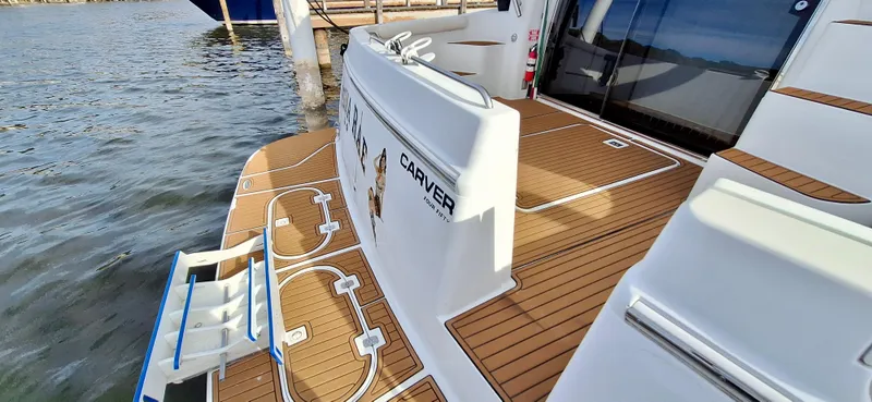 Regina Rae Yacht Photos Pics 1999 Carver 450 Voyager Pilothouse yacht with teak deck, docked by the water.