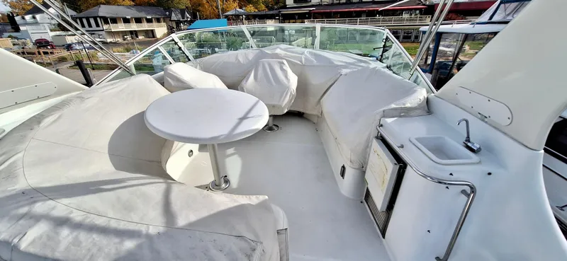 Regina Rae Yacht Photos Pics 1999 Carver 450 Voyager Pilothouse yacht deck with seating, table, and sink.