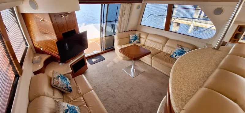 Regina Rae Yacht Photos Pics Luxurious interior of 1999 Carver 450 Voyager Pilothouse with leather seating and waterfront view.