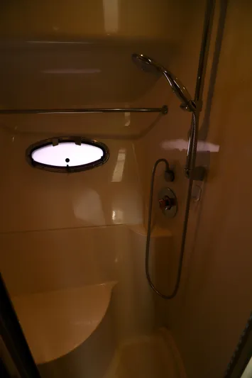 Regina Rae Yacht Photos Pics Shower area in 1999 Carver 450 Voyager Pilothouse with oval window and chrome fixtures.