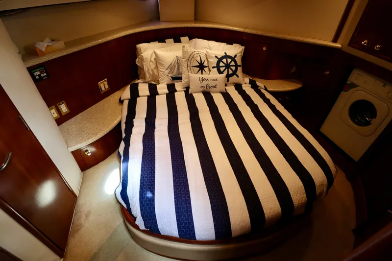 Regina Rae Yacht Photos Pics Cozy bedroom in 1999 Carver 450 Voyager Pilothouse with nautical decor and striped bedding.