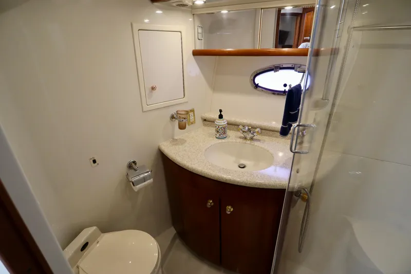 Regina Rae Yacht Photos Pics Bathroom interior of 1999 Carver 450 Voyager Pilothouse yacht, featuring sink and shower.